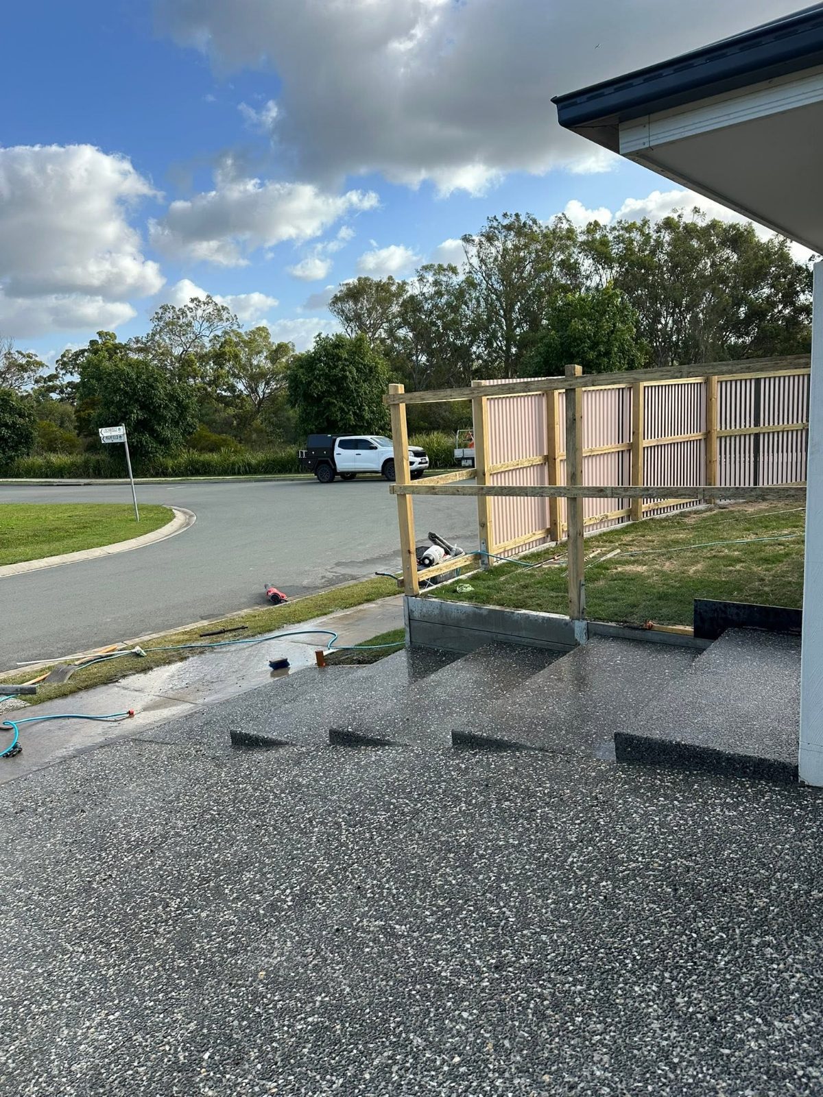 Finished concrete steps and exposed aggregate driveway
